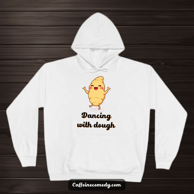 A delighted croissant character doing a happy dance, featured on a soft hoodie for ultimate cozy cheer.